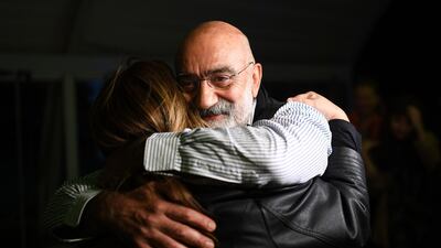 Turkish journalist and writer Ahmet Altan hugs his friends and relatives after being realised from prison. A Turkish court ordered journalist him to be released under judicial supervision despite sentencing him to more than 10 years in prison. AFP