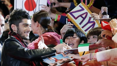 Zayn Malik of One Direction gives his autograph to Japanese fans during an event for their film One Direction: This Is Us, in Makuhari near Tokyo.Chart-topping boy band One Direction says Zayn Malik has left the group. The band confirmed his departure Wednesday, March 25, 2015 in a statement. Koji Sasahara / AP Photo