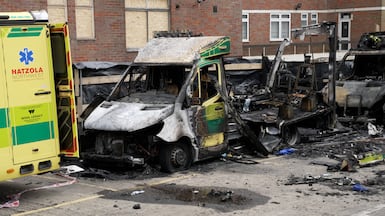 The burnt-out vehicles of a Jewish ambulance service, which were firebombed in London last year. PA