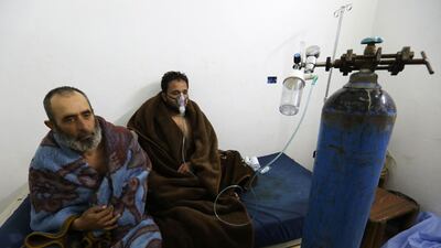 Syrians reportedly suffering from breathing difficulties following Syrian regime air strikes on the northwestern town of Saraqeb rest at a field hospital in a village on the outskirts of Saraqeb, due to the lack of hospitals in the town. Omar Haj Kadour / AFP