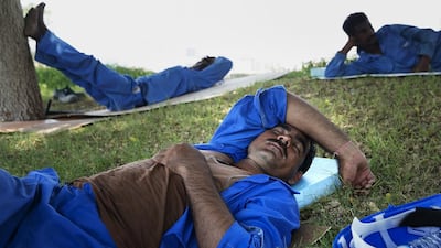 Labourers take advantage of a shaded area to catch some rest. The extended break starts from June 15. Silvia Razgova / The National