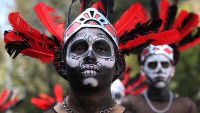 People dressed in traditional costumes participate in a parade during Day of the Dead celebrations in Mexico City. Mario Guzman / EPA