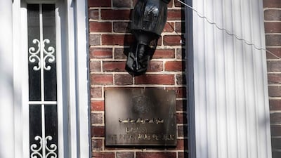 A weathered sign at the former Syrian embassy