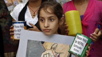 Indian children display one of their creations to collect relief funds for the victims of the Nepal earthquake outside an art school in Mumbai. Rajanish Kakade / AP Photo
