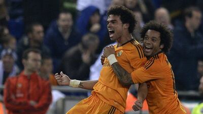 Pepe, left, celebrates after scoring the winner for Real on Sunday. Lluis Gene / AFP