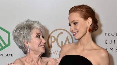 Rita Moreno and Jessica Chastain, wearing a black column Miu Miu dress, appear backstage at the 33rd Annual Producers Guild Awards on March 19, 2022 in Los Angeles. AP Images