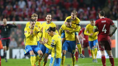 Zlatan Ibrahimovic is mobbed by teammates as Sweden celebrate reaching Euro 2016. Alex Livesey / Getty Images