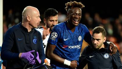 Chelsea striker Tammy Abraham is helped from the pitch after injuring his hip against Valencia in the Champions League. AFP