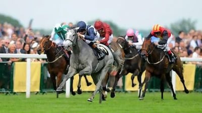 Richard Hughes rides Sky Lantern, grey horse, to victory ahead of Kenhope and Just The Judge in the Coronation Stakes during Day 4 of Royal Ascot yesterday.