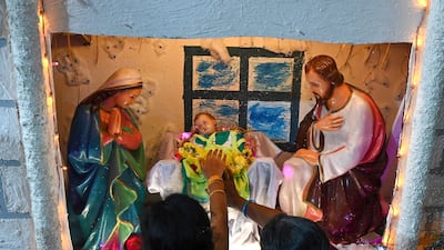 Worshippers pray at Sacred Heart Shrine Church to celebrate Christmas in Chennai, India. AFP