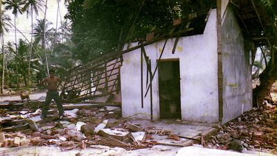 Sugith Gamage, Sudam Gamage’s younger brother, stands beside his destroyed family home after the tsunami in Midigama, Sri Lanka. Courtesy Sudam Gamage