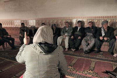 Mrs Kurdistan Rasul talks to the men of Gomasheen in the village mosque. Florian Neuhof for The National