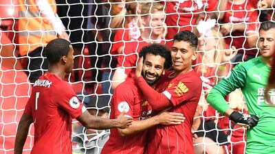 Liverpool's Egyptian striker Mohamed Salah celebrates with Roberto Firmino after scoring the team's third goal against Newcastle. EPA