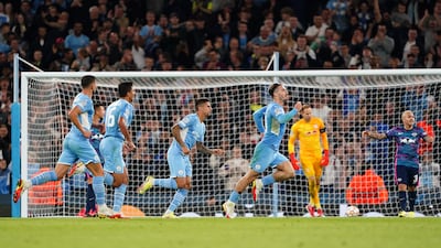Manchester City's Jack Grealish, right, celebrates scoring his side's fourth goal against Leipzig in the Champions League at the Etihad Stadium in Manchester. PA