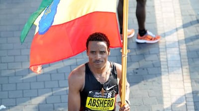 Ethiopia's Ayele Abshero waves his national flag after winning the men's Dubai Marathon in the Gulf emirate on January 27, 2012. AFP PHOTO/STR / AFP / STR