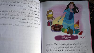 One of the new textbooks features a picture of a woman without head covering. Salah Malkawi for The National