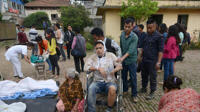 An injured man is transported into an open area following an 7.9 earthquake, at Lalitpur on the outskirts of Kathmandu. Prakash Mathema / AFP