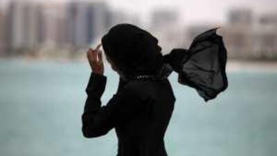 The winds blow unimpeded across Abu Dhabi's breakwater, where a Sudanese woman was viewing the skyline.