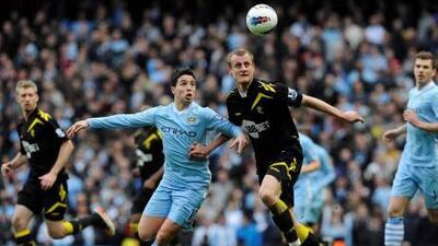 Manchester City's Samir Nasri, left, battles for the ball with Bolton's David Wheater. Nigel Roddis / Reuters