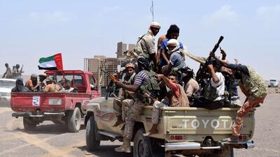 Pro-government fighters fly the flag of the UAE, a key member of a regional coalition backing Yemeni president Abdrabu Mansur Hadi, as they head from Aden towards Taez province. Saleh Al Obeidi / AFP / October 1, 2015