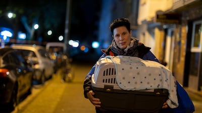 A Dusseldorf resident brought her cat as she left her apartment while the wartime bomb was deactivated. Getty Images