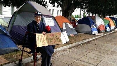 Lucy Horwitz joins hundreds of anti-Wall Street protestors camped on the grounds of the Los Angeles city hall as part of the Occupy LA movement. Mike Nelson / EPA