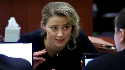 Actress Amber Heard speaks to her legal team. EPA