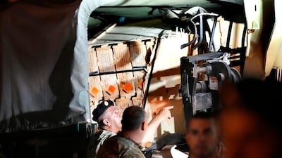 Lebanese soldiers load boxes on their military vehicle after they remove them from the lorry. AP