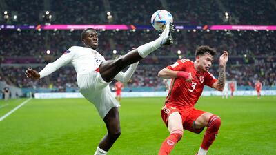 Tim Weah of the United States, left, clears the ball in front of Wales' Neco Williams. AP