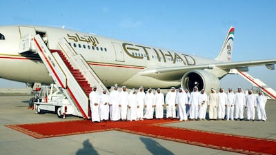 Emirati officials pose in front of the new carrier "Etihad", or "Unity", at a ceremonial flight in Al Ain on 3 November 2003. The airline launched commercial operations with a direct service to Beirut. AFP