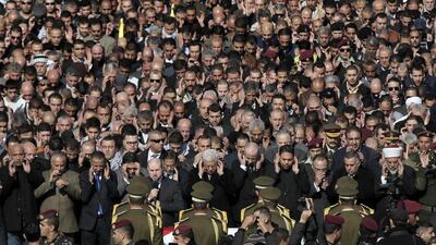 Palestinian president Mahmoud Abbas, centre bottom, prays near the coffin of senior Palestinian official Ziad Abu Ein during his funeral in the West Bank city of Ramallah on December 11, 2014. Ahmad Gharabli / AFP