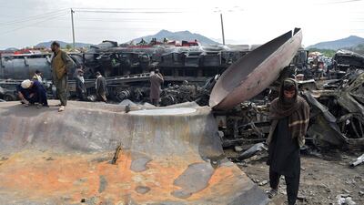 Local residents and owners of fuel tankers inspect the debris following an overnight ablaze in which several fuel tankers caught fire at Qala-e-Murad Bek area on the outskirts of Kabul. AFP
