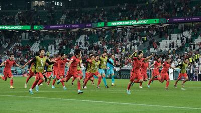 South Korea's players celebrate after finding out they had qualified for the last-16 ahead of Uruguay. AP