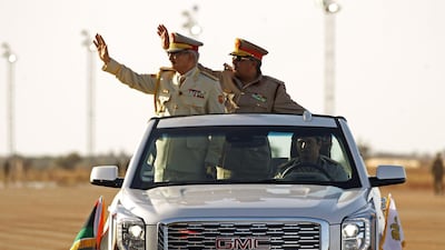 Libya's Khalifa Haftar (L) attends a military parade in the eastern city of Benghazi on May 7, 2018, during which he announced a military offensive to take from "terrorists" the city of Derna. Abdullah Doma / AFP