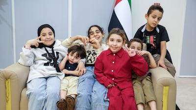 Rahaf, in red, with her family at Emirates Humanitarian City in Abu Dhabi. From left, Rama, 15, Imran, two, Yara, 12, Mustaffa, six and Ahmad, nine. Victor Besa / The National