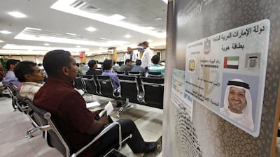 Residents wait to be photographed for their Emirates ID. Bank customers that did not supply the document are now facing disruption. Jeff Topping/The National