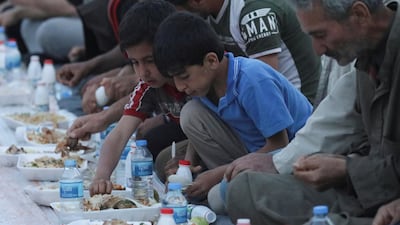 Boys eat their Iftar meal provided by a group of volunteers in a damaged neighbourhood, amid fear for the coronavirus disease outbreak, in Atarib, Aleppo countryside Syria May 7. In Syria, UNICEF is transporting clean water via lorries into some of the most devastated cities and IDP camps, but this is only a temporary solution and further highlights the need for better water management to combat future viral outbreaks. Khalil Ashawi / Reuters