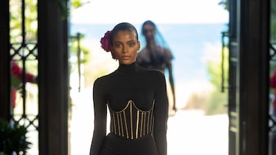 A simple dress is cinched with the gilded bars of a corset for Alta Moda