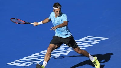Roger Federer of Switzerland chases down the ball during a training session at the Australian Open tennis championship in Melbourne, Australia, Sunday, Jan. 18, 2015. (AP Photo/Bernat Armangue)