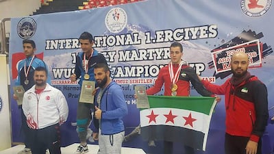 Mohammed Mustafa (second from right), a member of the Free Syrian Body of Sports’ Wushu Kung Fu team, pictured with the flag and his medals — three gold, one silver and one bronze — at the Kayseri International Championship in Kayseri, Turkey on December 25, 2016. Courtesy Public Authority for Sports and Youth in Syria