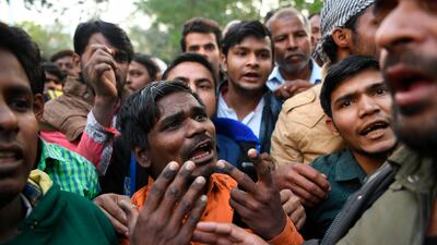 Relatives of victims in the New Delhi factory fire plead for ambulances to carry the bodies back to their home towns on December 9, 2019. AFP