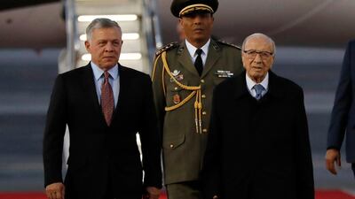 King Abdullah II of Jordan, left, walks next of Tunisian President Beji Caid Essebsi, right, as they review the honor guard upon his arrival. AP Photo