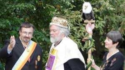 Self-proclaimed His Imperial Majesty George II of the Empire of Atlantium, left, self-proclaimed Prince Paul Delprat of the Principality of Wy, centre, and his princess Susan chat during a break.