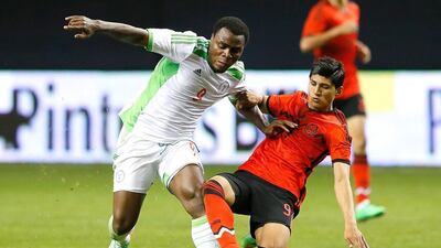 Alan Pulido, right, of Mexico challenges for the ball with Emmanuel Emenike of Nigeria during their international friendly at the Georgia Dome on March 5, 2014, in Atlanta, Georgia. Kevin C Cox /Getty Images