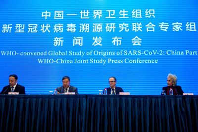 Members of the WHO team investigating the origins of the coronavirus join Liang Wannian, the head of a panel on coronavirus response at China's National Health Commission, at a news conference in Wuhan, central China. Reuters