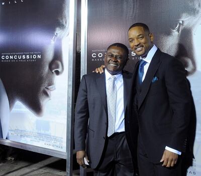 Dr Bennet Omalu, left, and Will Smith arrive at the screening of Concussion in California. Gregg DeGuire / Getty Images