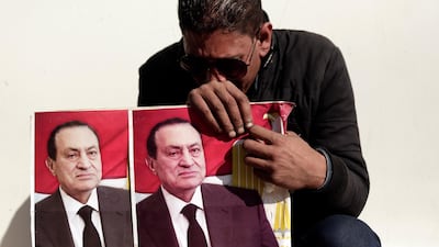 A supporter of former Egyptian President Hosni Mubarak weeps outside of Mosheer Tantawy mosque before his funeral. AP Photo