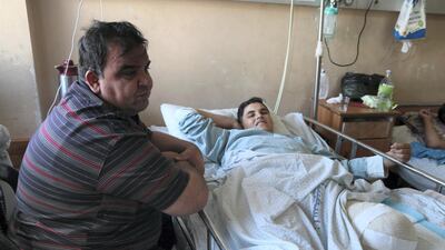 Bashir Faraj and his father Mohammed in Gaza's Al Shifa hospital, June 6, 2018. Florian Neuhof for The National