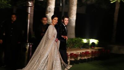 Newlyweds Priyanka Chopra, 36, and Nick Jonas, 26, pose for a photograph during a reception at a hotel in New Delhi on December 4, 2018. Photo: AP