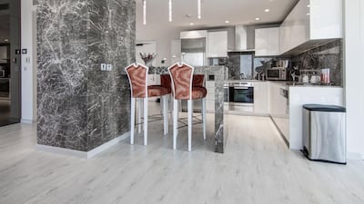 The dining and kitchen area of the apartment in the Burj Khalifa. Courtesy of Luxhabitat